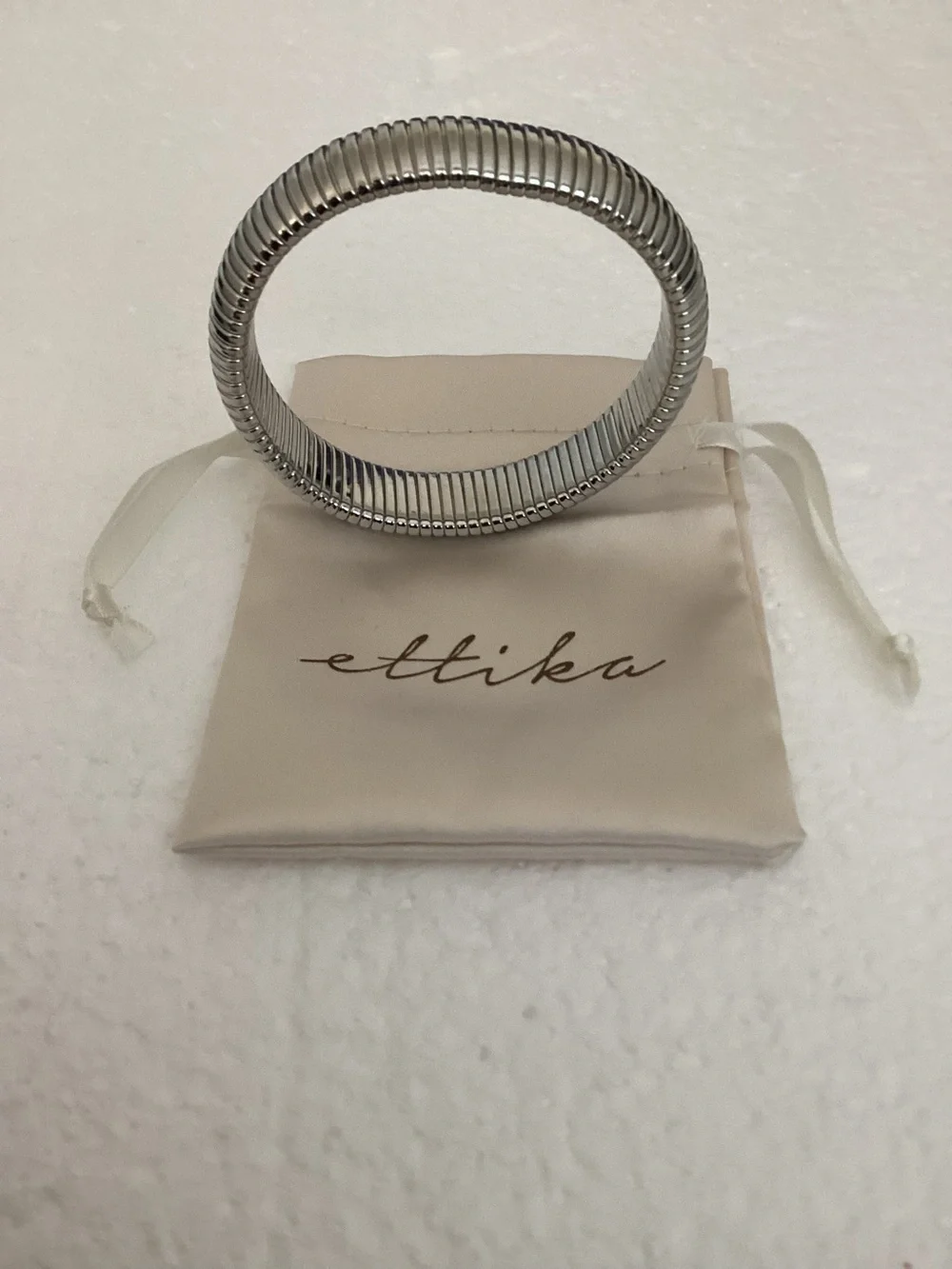 This Ettika silver-plated flexible tubogas-style stretch cuff silver tone brace